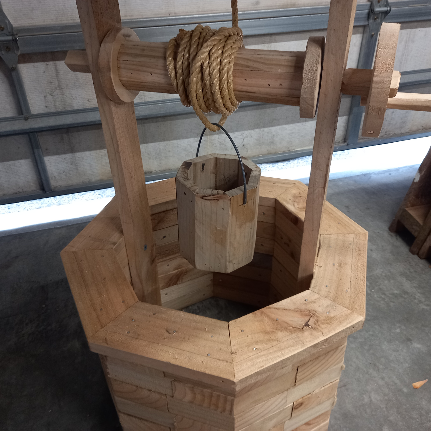 DIY plans to build a wood-brick wishing well with a brushwood roof