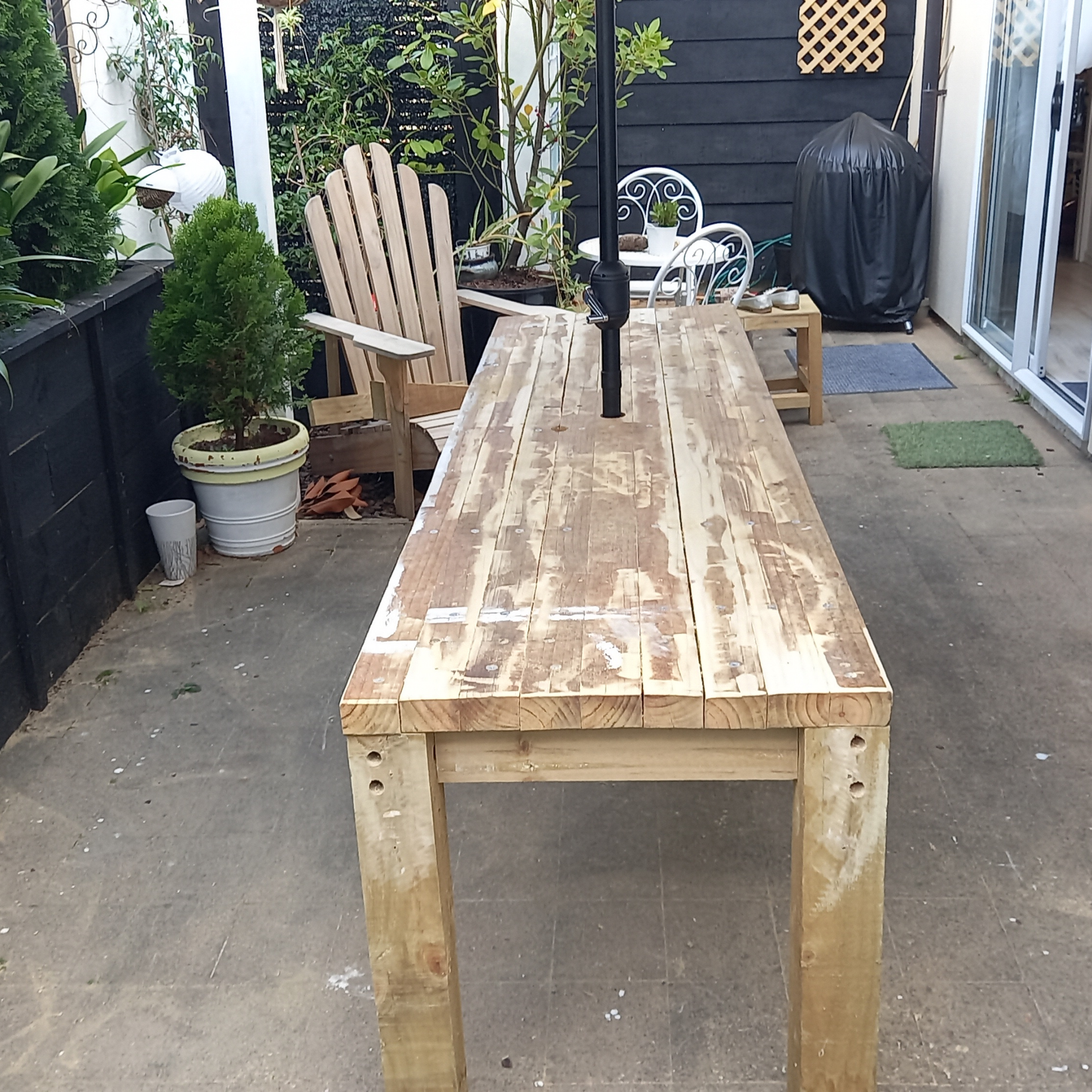 DIY plans to build a rustic 8ft (2.4m) long, narrow outdoor dining table that can seat 12 people